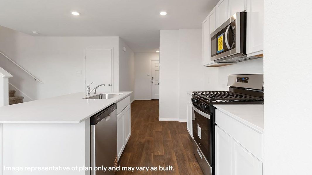 Kitchen featuring stainless steel appliances, dark wood-style flooring, recessed lighting, white cabinets, and a center island with sink