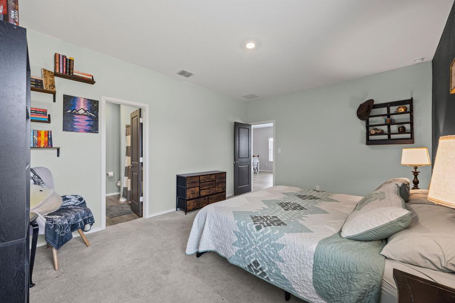 Primary bedroom featuring carpet and ensuite bathroom Primary bedroom featuring carpet and ensuite bathroom