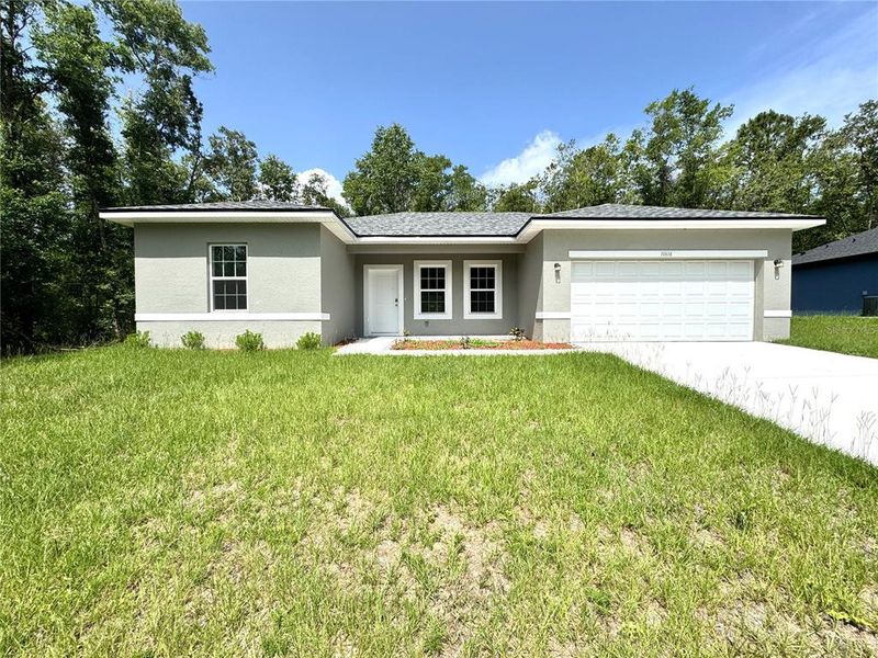 Front exterior of a new home in , Citrus Springs, FL, highlighting curb appeal (Image 1).