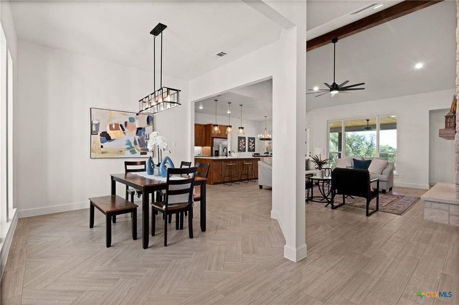 Dining room with ceiling fan, a chandelier, recessed lighting, and light wood finished floors