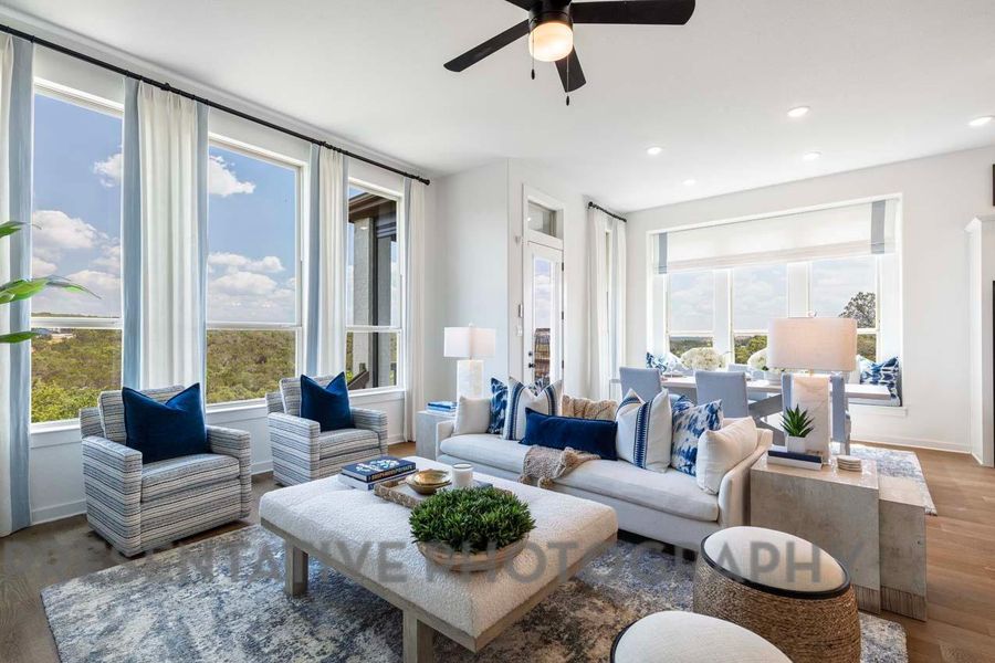 Living room with recessed lighting, ceiling fan, baseboards, and wood finished floors