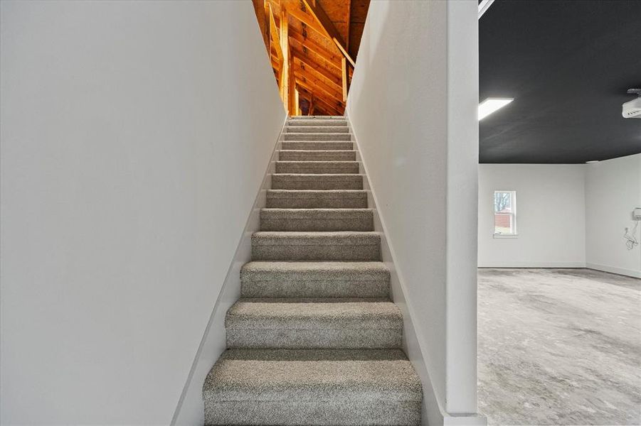 Staircase featuring concrete floors