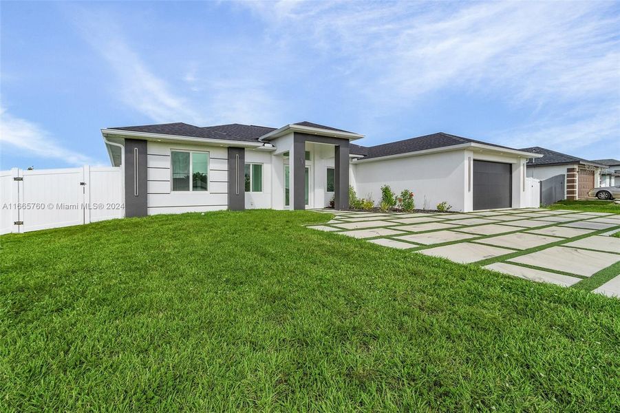 Front exterior of a new home in , Cape Coral, FL, highlighting curb appeal (Image 15). Front exterior of a new home in , Cape Coral, FL, highlighting curb appeal (Image 15).
