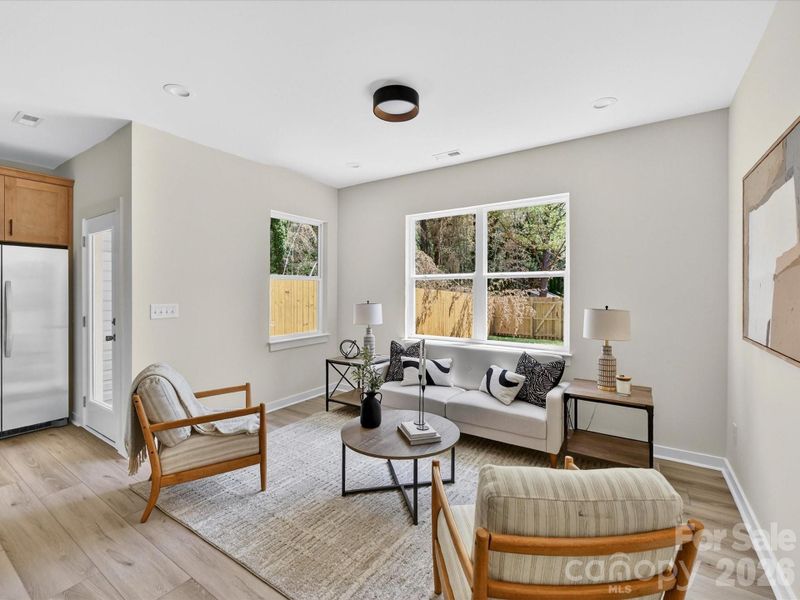 Bright and inviting family room filled with natural light, offering an open layout that seamlessly connects to the kitchen and dining area for comfortable everyday living. Bright and inviting family room filled with natural light, offering an open layout that seamlessly connects to the kitchen and dining area for comfortable everyday living.