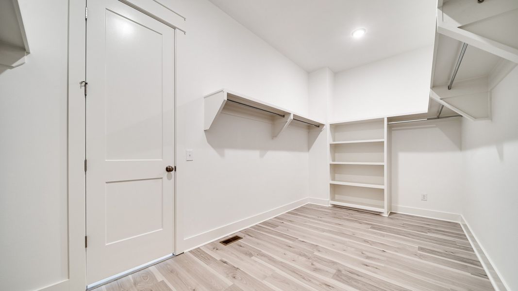 Large walk-in closet showing built-in shelving
