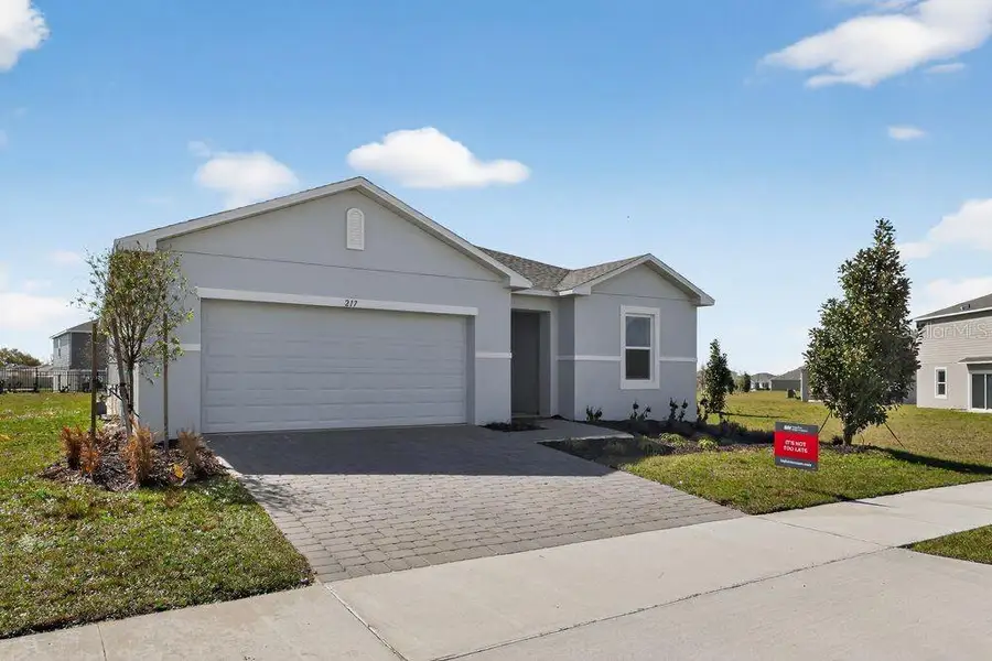 Front exterior of a new home in Waterstone, Groveland, FL, highlighting curb appeal (Image 2). Front exterior of a new home in Waterstone, Groveland, FL, highlighting curb appeal (Image 2).