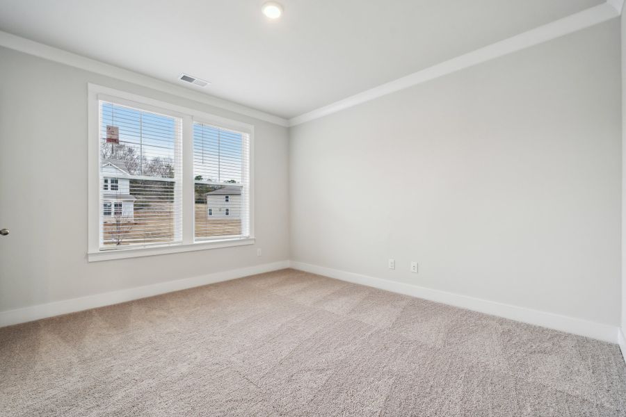 A room with a window and a carpet. A room with a window and a carpet.