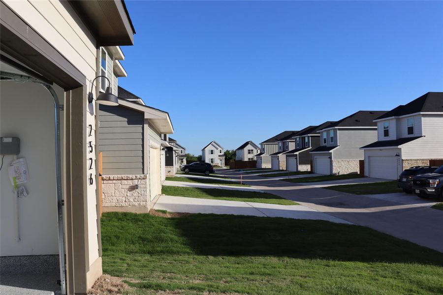 A newly constructed neighborhood offers contemporary residences with attached garages and tidy landscaping.
