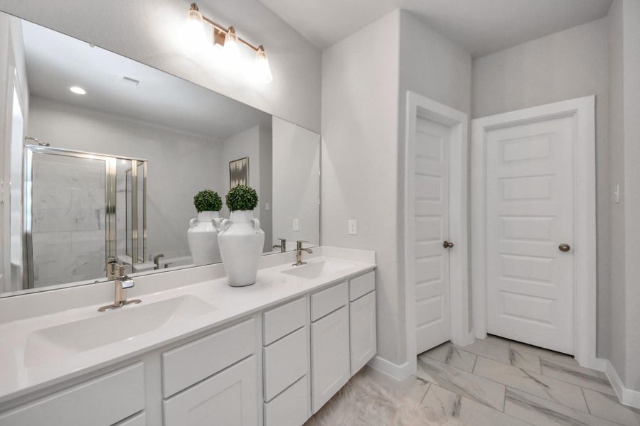 Elevate your daily routine at the elegant vanity, now equipped with double sinks, light countertops, modern hardware, and beautiful vanity lights. Elevate your daily routine at the elegant vanity, now equipped with double sinks, light countertops, modern hardware, and beautiful vanity lights.