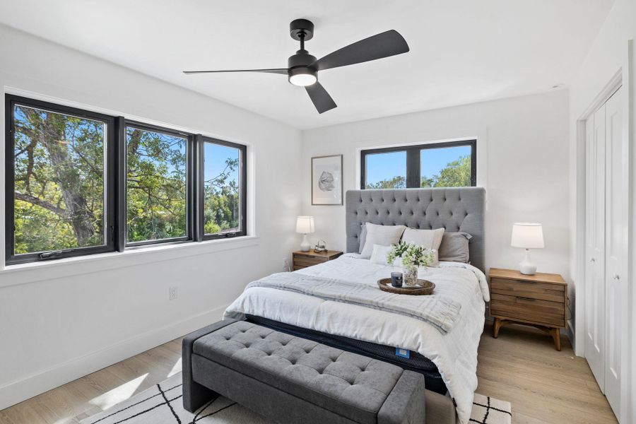 Bedroom featuring wood finished floors, ceiling fan, and a closet