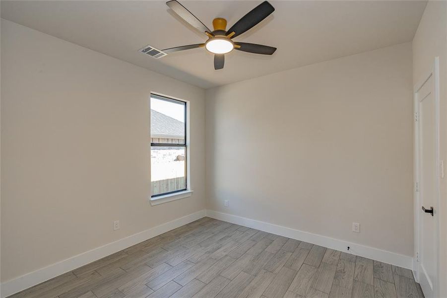 Spare room featuring ceiling fan and light hardwood / wood-style floors