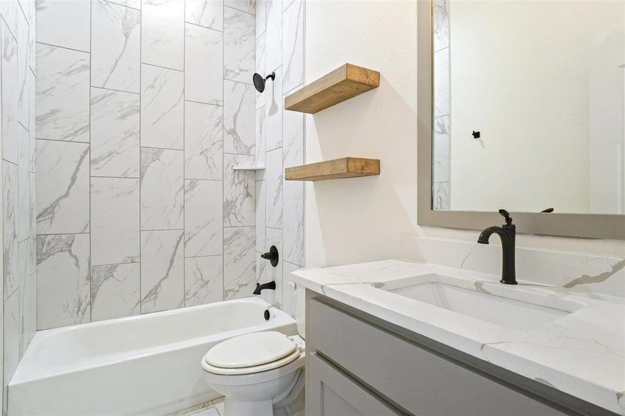 Bathroom with shower / washtub combination and vanity