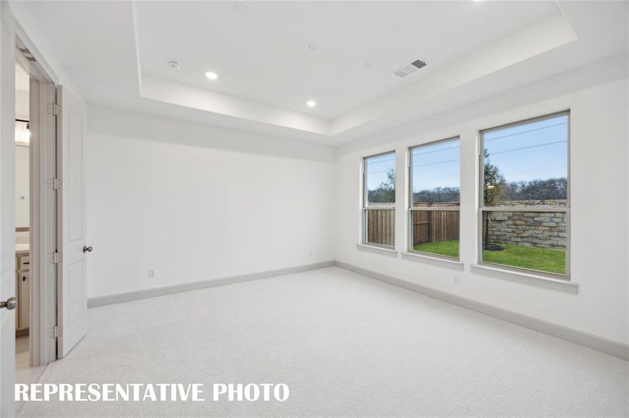 Located at the rear of the home for additional privacy, this owner's suite is the perfect space for rest and relaxation.  REPRESENTATIVE PHOTO