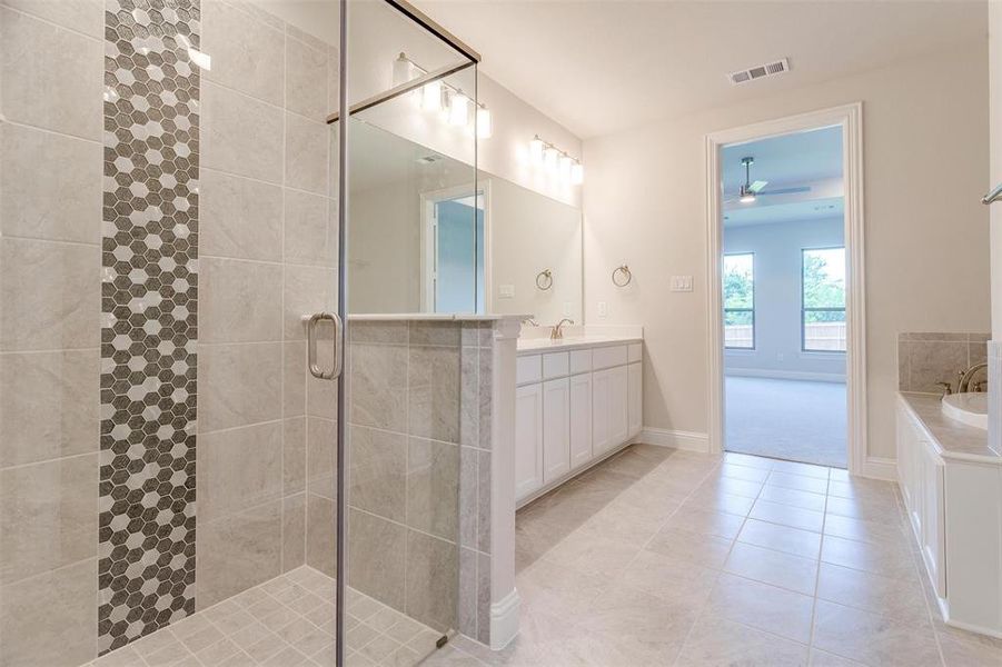 Bathroom with vanity, tile patterned flooring, ceiling fan, and shower with separate bathtub