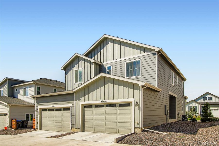 Front exterior of a new home in Haskins Station, Arvada, CO, highlighting curb appeal (Image 1).