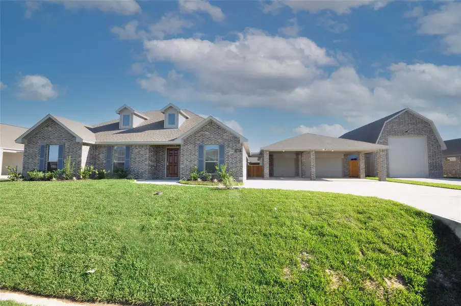 Front exterior of a new home in Pedregal, League City, TX, highlighting curb appeal (Image 20).