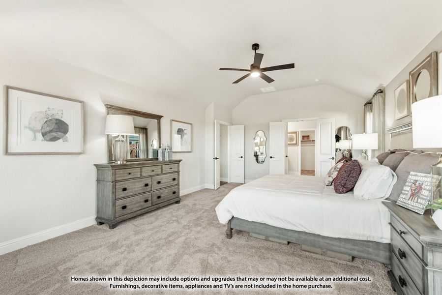 Master bedroom with vaulted ceiling, ceiling fan, carpet floors, and walk-in closet entrance visible in background. Master bedroom with vaulted ceiling, ceiling fan, carpet floors, and walk-in closet entrance visible in background.