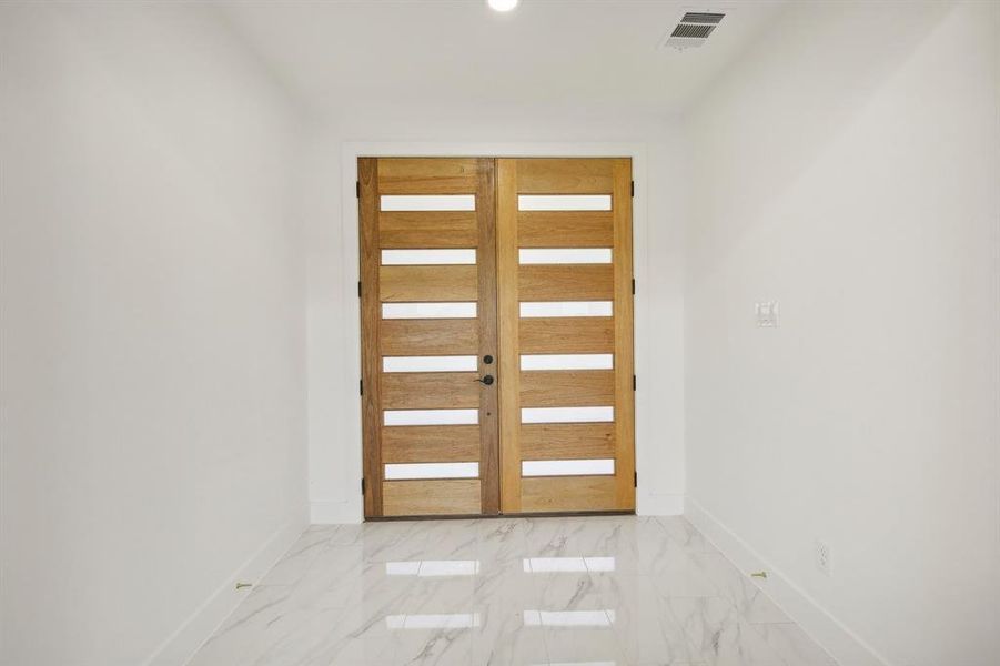 Doorway featuring marble finish floors, recessed lighting, and french doors Doorway featuring marble finish floors, recessed lighting, and french doors
