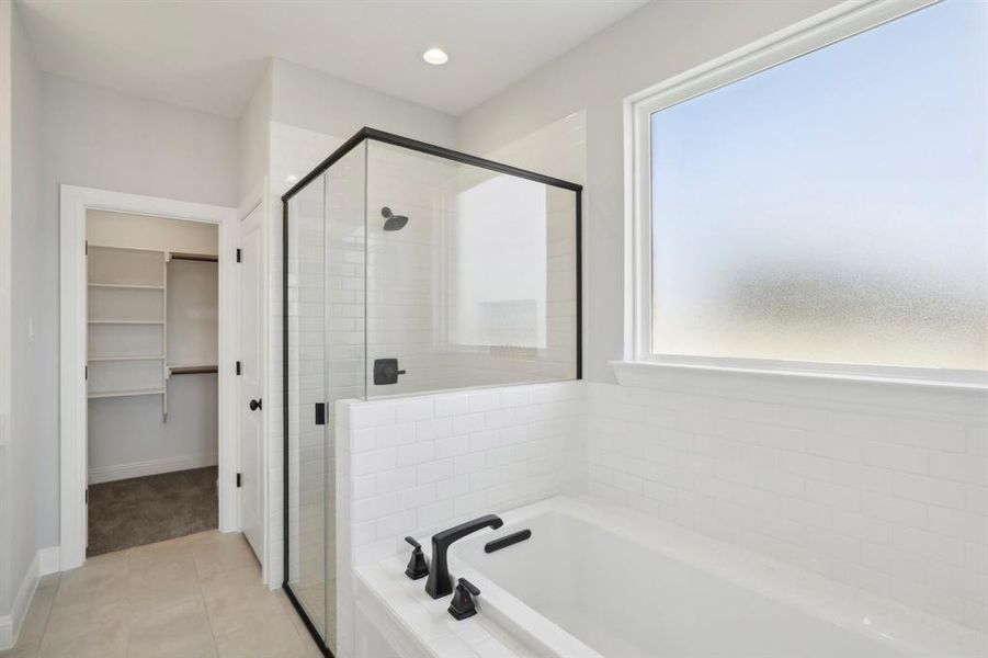 Bathroom with plus walk in shower and tile patterned flooring