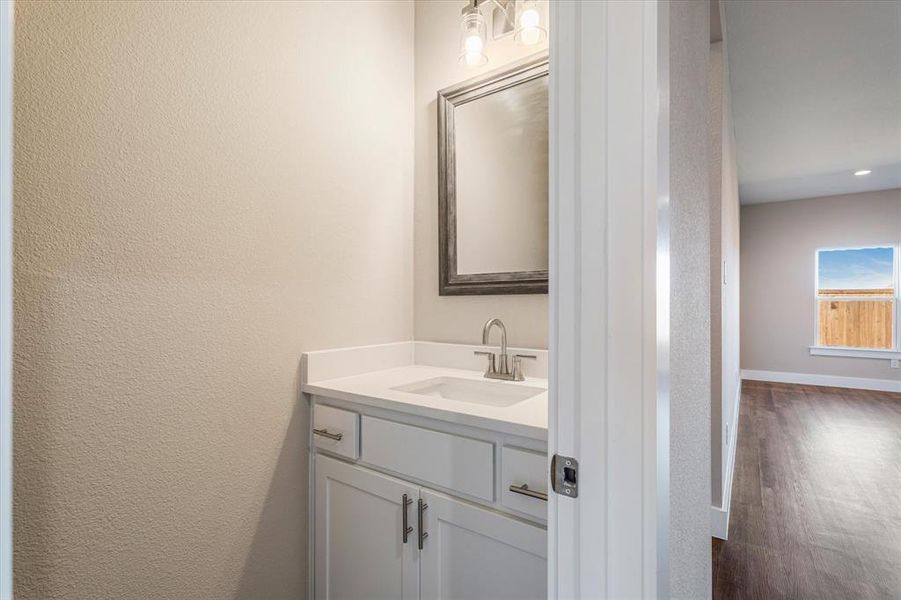 Bathroom featuring hardwood / wood-style flooring and vanity Bathroom featuring hardwood / wood-style flooring and vanity