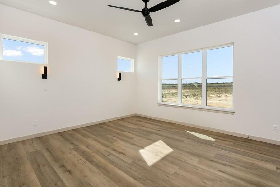 Spare room with light wood-style floors, ceiling fan, and recessed lighting Spare room with light wood-style floors, ceiling fan, and recessed lighting