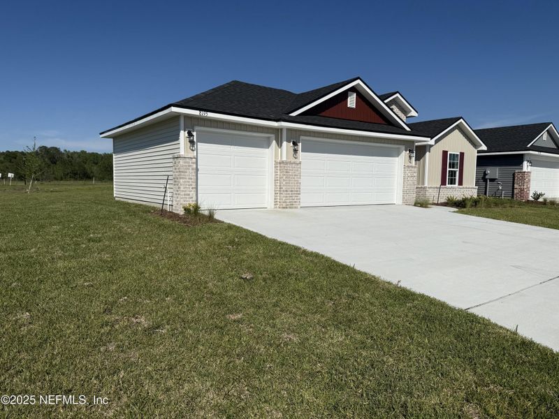 Front exterior of a new home in Summerglen, Jacksonville, FL, highlighting curb appeal (Image 15). Front exterior of a new home in Summerglen, Jacksonville, FL, highlighting curb appeal (Image 15).