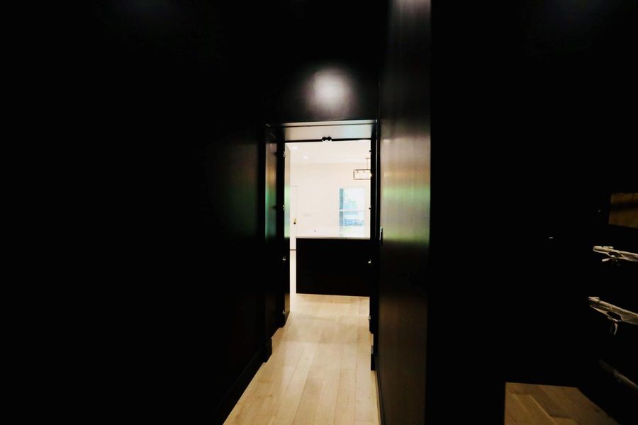 Corridor with light wood-style flooring