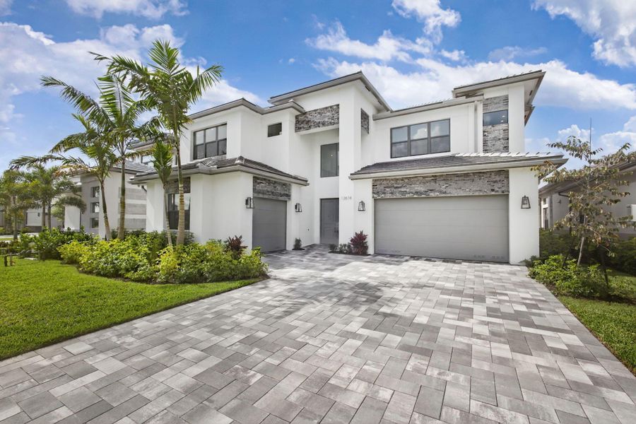 Front exterior of a new home in Apex at Avenir, Palm Beach Gardens, FL, highlighting curb appeal (Image 25).
