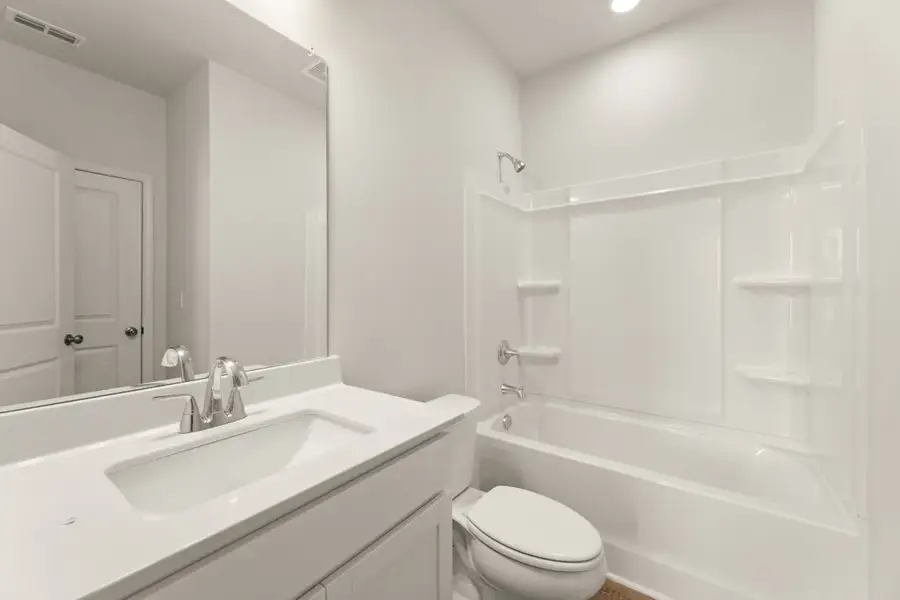 A bathroom with a tub sink and toilet. A bathroom with a tub sink and toilet.