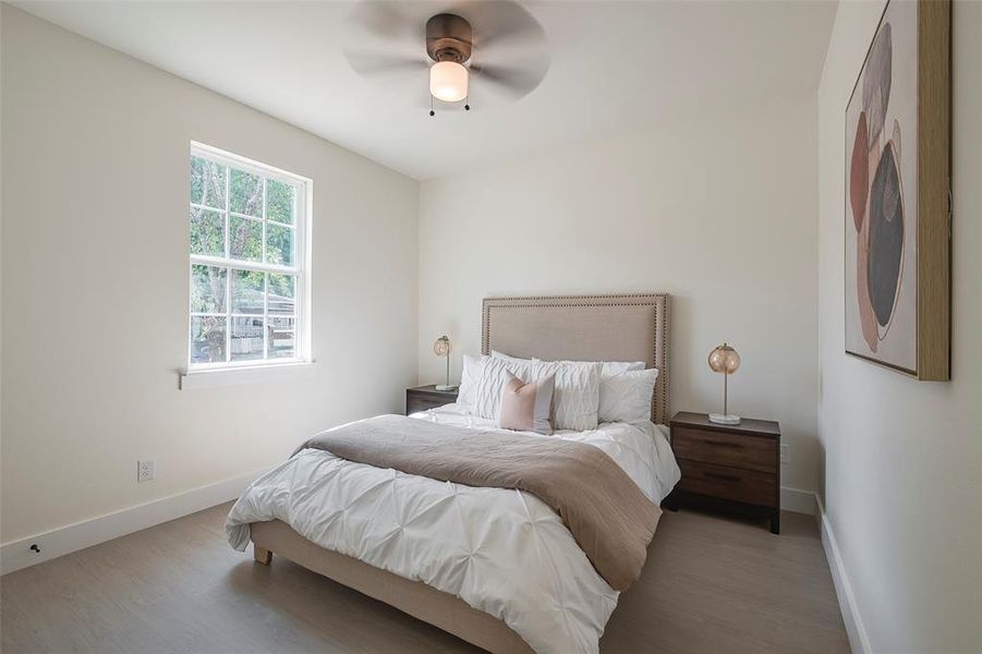 Bedroom featuring ceiling fan and hardwood / wood-style flooring