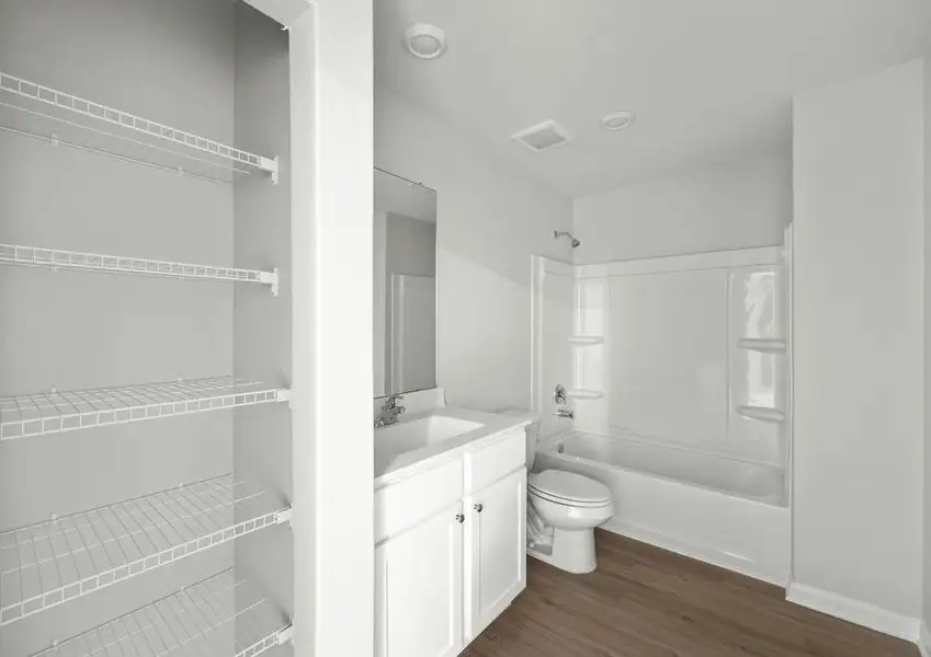 The master bathroom has tub/shower combo and a storage closet.