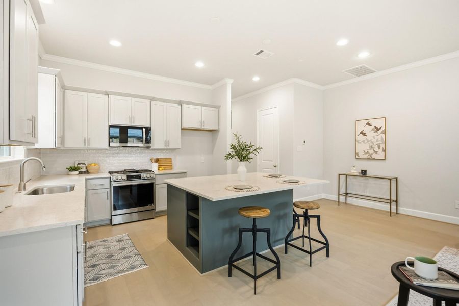Comfort meets chic: Dive into this spacious kitchen's inviting island that’s perfect for brunch, buffets, and big laughs with loved ones. Comfort meets chic: Dive into this spacious kitchen's inviting island that’s perfect for brunch, buffets, and big laughs with loved ones.