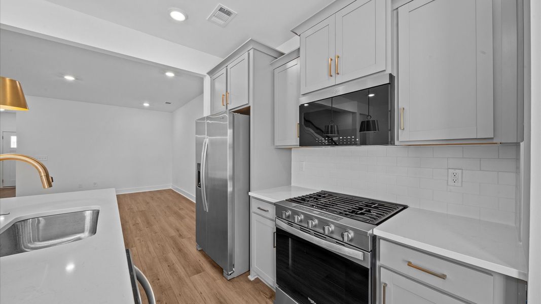 Stunning open concept kitchen in two story townhome at Ransdell Pointe by DRB Homes in Spartanburg, SC