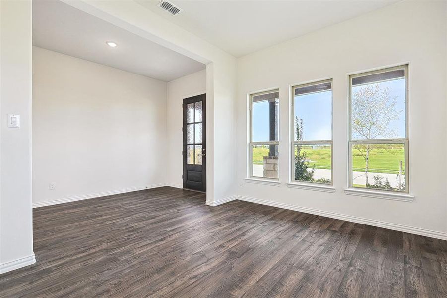 Unfurnished room featuring dark wood-type flooring