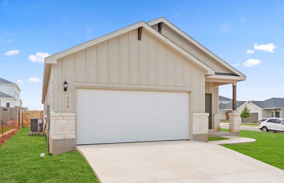 Front exterior of a new home in Sunfield, Buda, TX, highlighting curb appeal (Image 21). Front exterior of a new home in Sunfield, Buda, TX, highlighting curb appeal (Image 21).