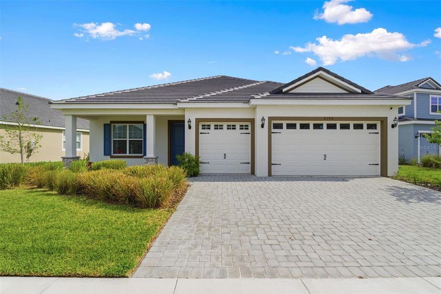 Front exterior of a new home in Tamarack at Two Rivers, Zephyrhills, FL, highlighting curb appeal (Image 27).