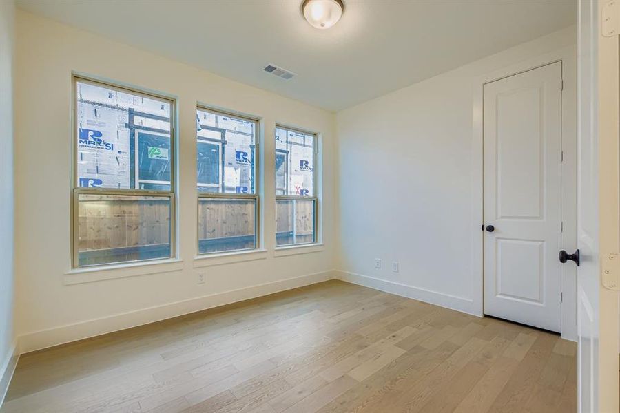 Empty room with light wood-style floors and baseboards