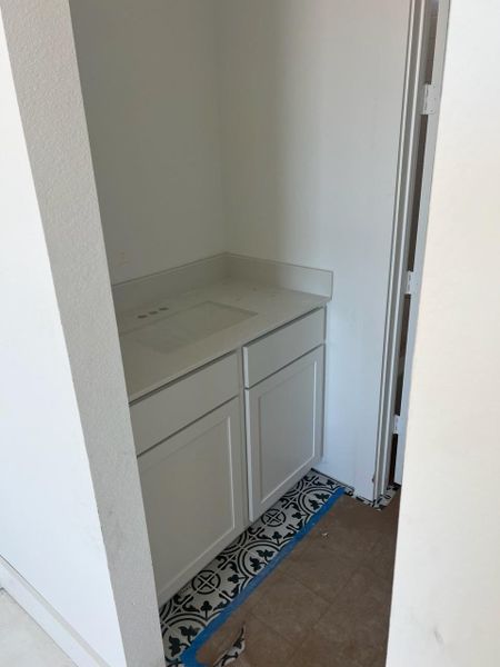 Jack-n-Jill secondary bathroom with a single sink on each side of the bathroom Jack-n-Jill secondary bathroom with a single sink on each side of the bathroom