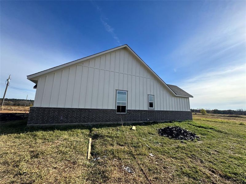 View of property exterior with a lawn