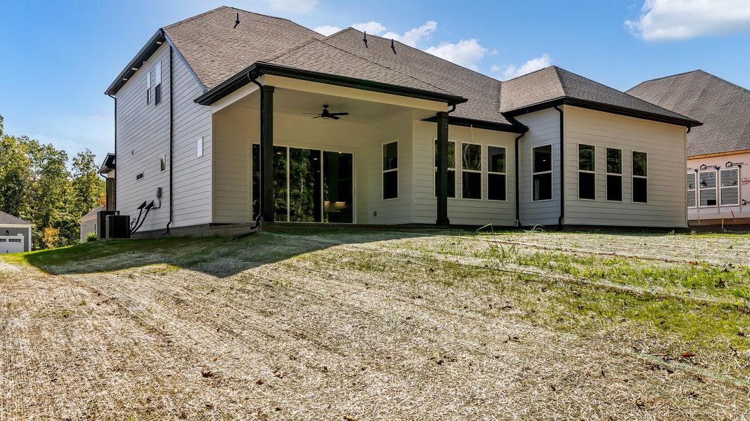 Exterior of home with covered rear porch (Representative of finished home)