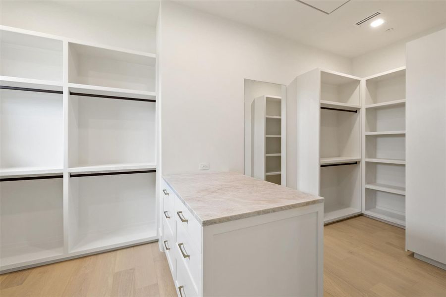 Spacious closet featuring light wood-style floors Spacious closet featuring light wood-style floors