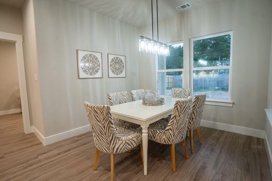 Dining room featuring wood finished floors and baseboards