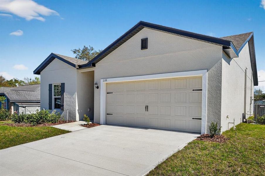 Front exterior of a new home in , Deltona, FL, highlighting curb appeal (Image 21). Front exterior of a new home in , Deltona, FL, highlighting curb appeal (Image 21).