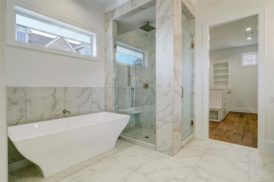 Primary bath displays a soaking tub & walk-in shower