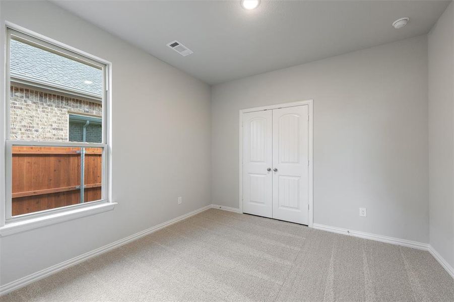 Unfurnished bedroom with light carpet, a closet, and recessed lighting