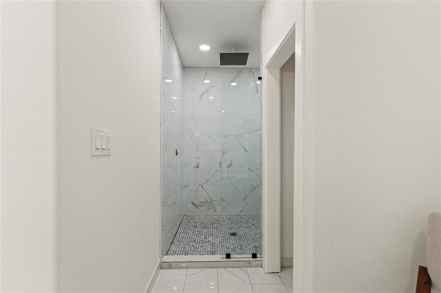 Bathroom with marble finish floors, a marble finish shower, and recessed lighting Bathroom with marble finish floors, a marble finish shower, and recessed lighting