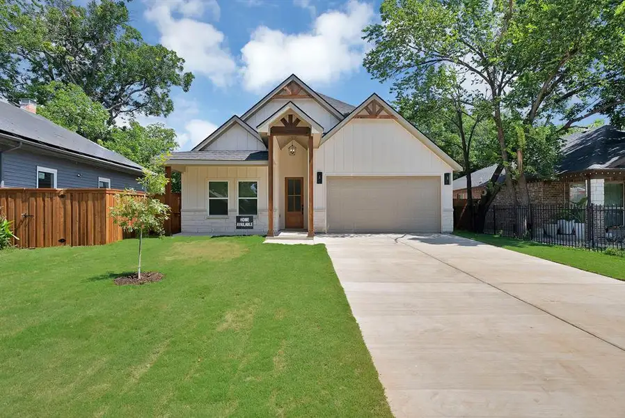 Contemporary Craftsman-style exterior featuring a prominent two-car garage, board and batten siding, and stone accents Contemporary Craftsman-style exterior featuring a prominent two-car garage, board and batten siding, and stone accents