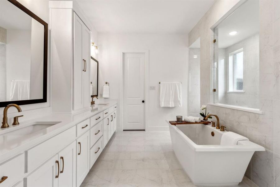 Main Bathroom with dual vanity, tile walls, a washtub, and tile patterned floors