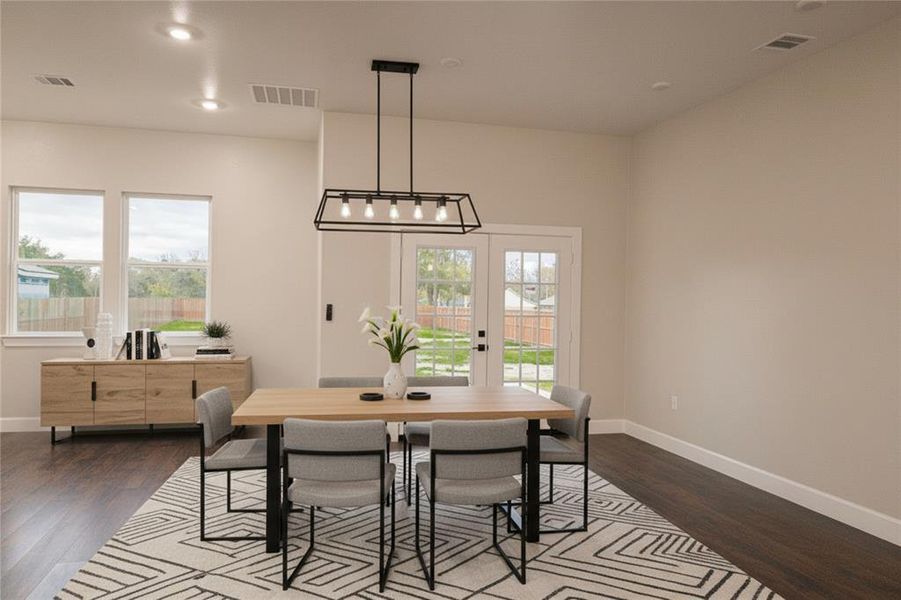 Dining room featuring healthy amount of natural light, dark wood-style floors, and recessed lighting Dining room featuring healthy amount of natural light, dark wood-style floors, and recessed lighting