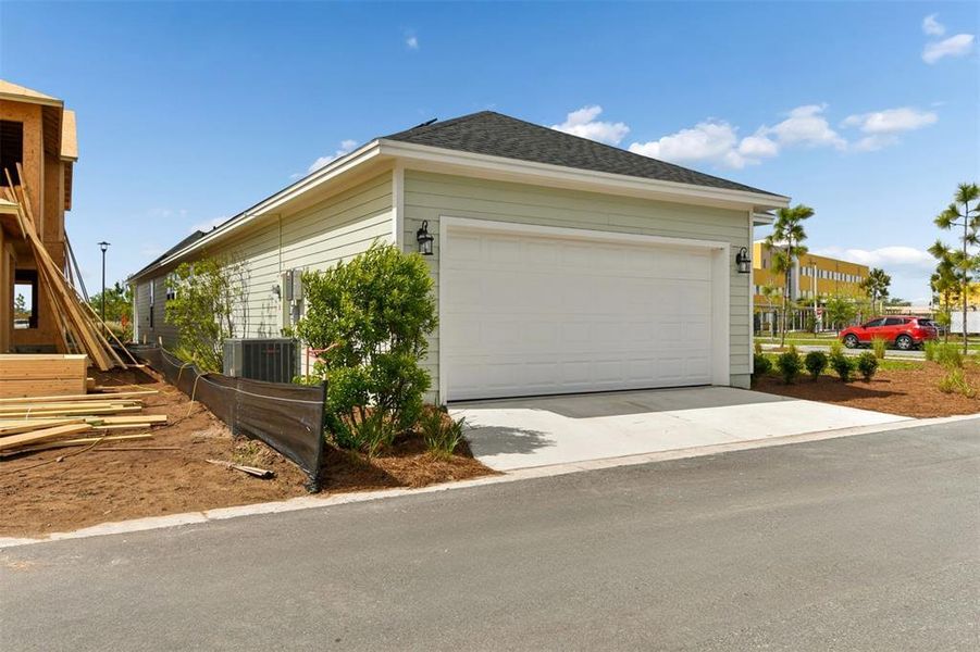 Front exterior of a new home in Weslyn Park in Sunbridge 34', St. Cloud, FL, highlighting curb appeal (Image 20).